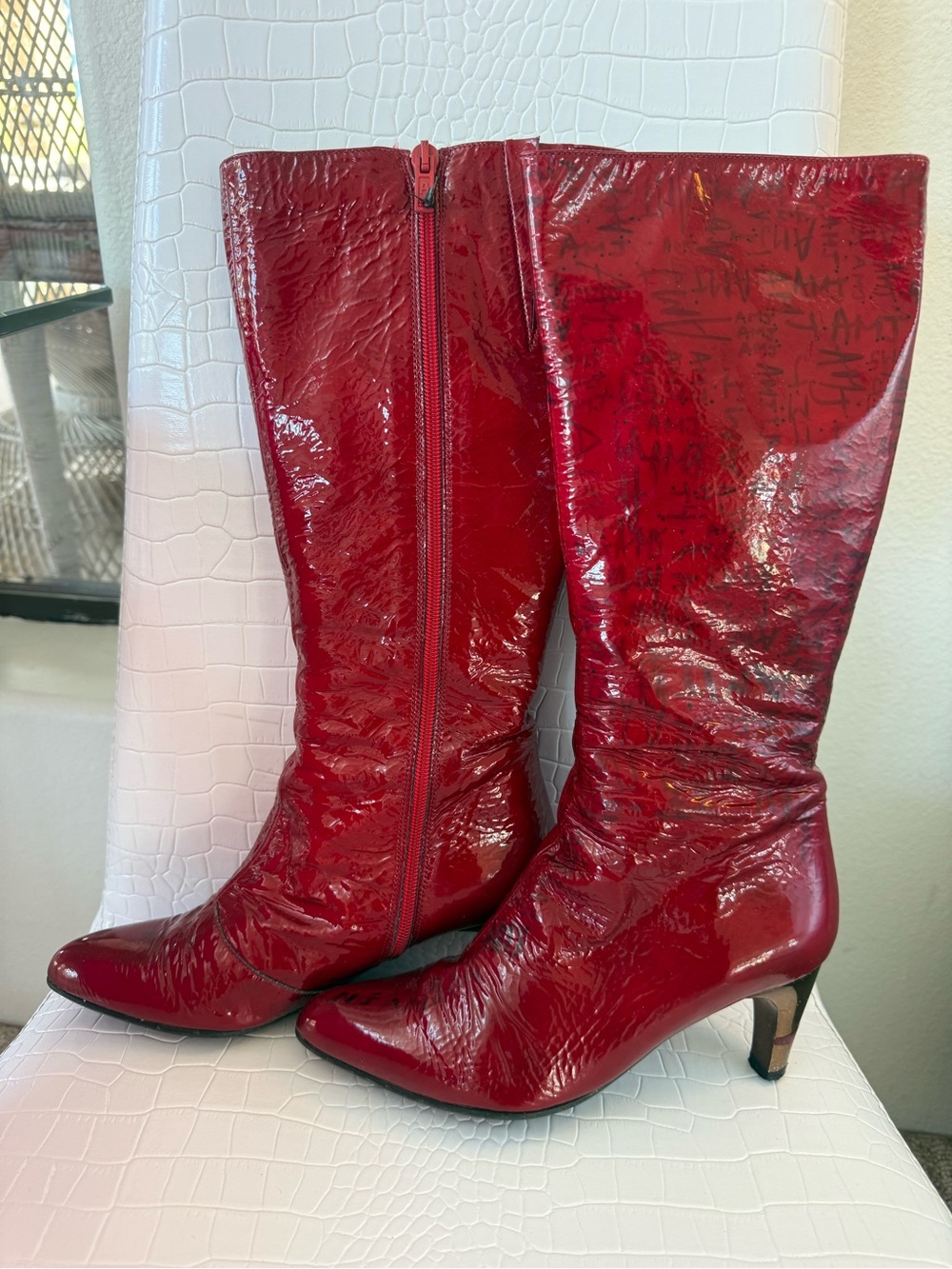 Red shiny leather “Azurée” Cannes France w/ black writing &  gold hills